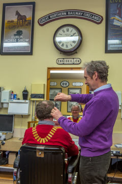 President Kenny Fisher gets a hair cut